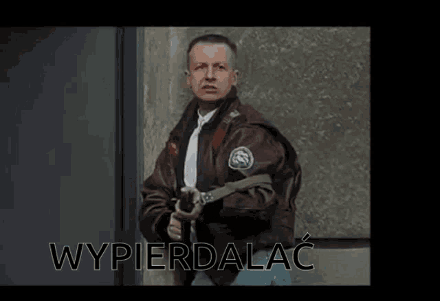 a man in a brown jacket holding a gun with the word wypierdalac above him