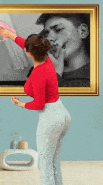 a woman is standing in front of a framed picture of a boy