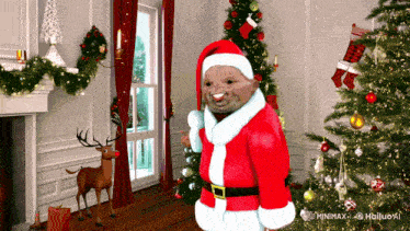 a man dressed as santa claus stands in front of a christmas tree in a living room