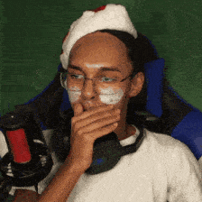 a man wearing a santa hat and headphones covering his mouth