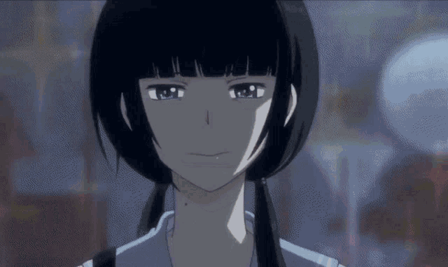a girl with black hair and blue eyes is smiling and looking at the camera