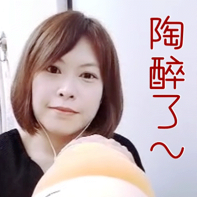 a woman is holding a stuffed animal with chinese writing on the bottom