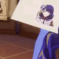 a person is holding a piece of paper with a drawing of a girl on it .