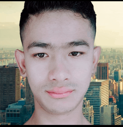 a young man with a city in the background is smiling