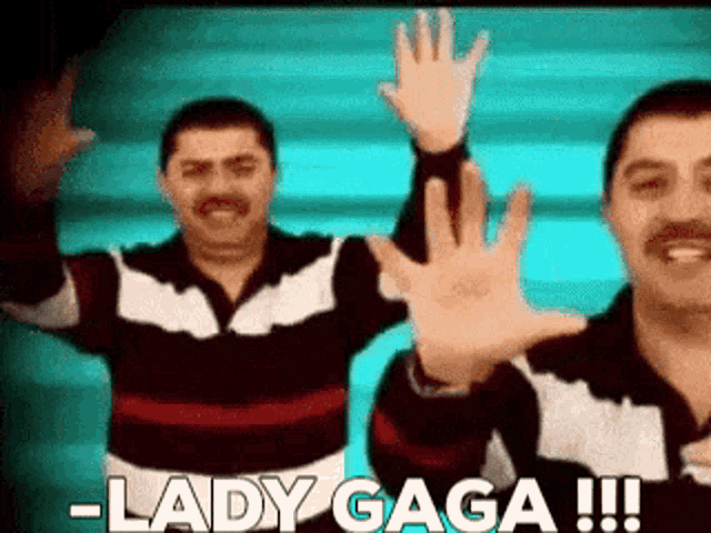 two men are waving their hands in the air with the words lady gaga !!! below them .