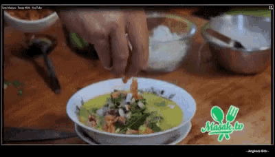 a screenshot of a video showing a bowl of food with a green logo that says ' masala tv '
