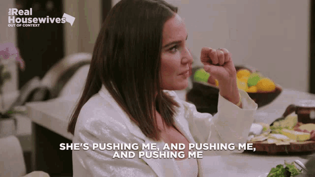 a woman says she 's pushing me and pushing me and pushing me while sitting at a table