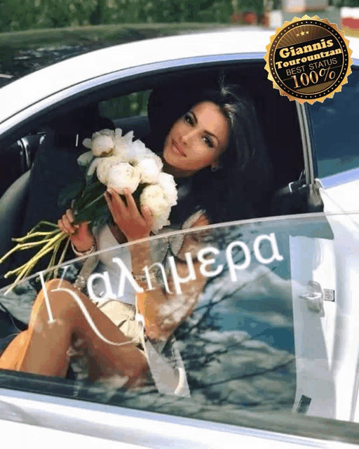 a woman is sitting in a white car holding flowers