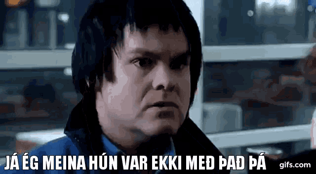 a man with black hair and a blue shirt is making a funny face and says ja eg meina hun var