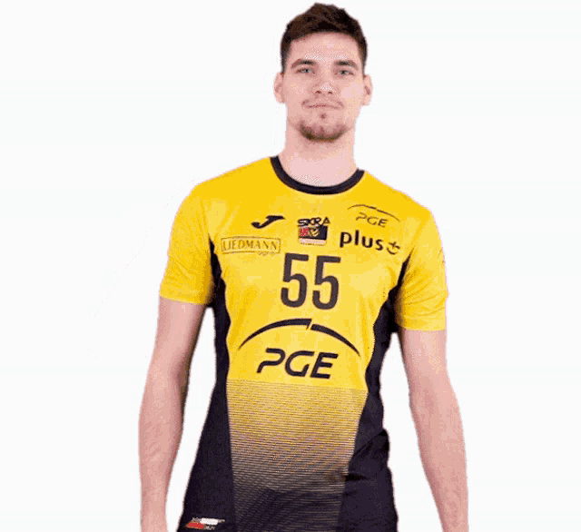 a man wearing a yellow and black pge jersey