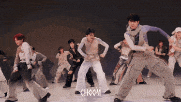 a group of young men are dancing in a choom video