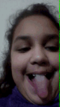 a close up of a woman 's face with her tongue sticking out