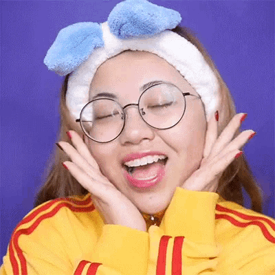 a woman wearing glasses and a headband with a bow on it