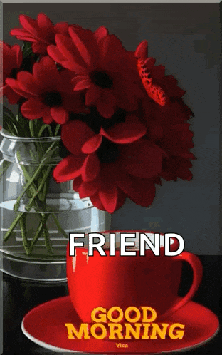 a red cup of coffee sits next to a vase of red flowers with a butterfly on it ..