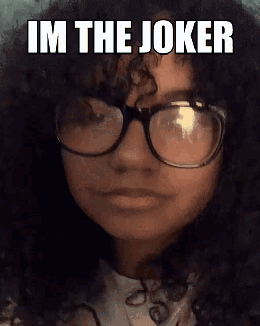 a girl with curly hair is wearing glasses and the caption says " im the joker "
