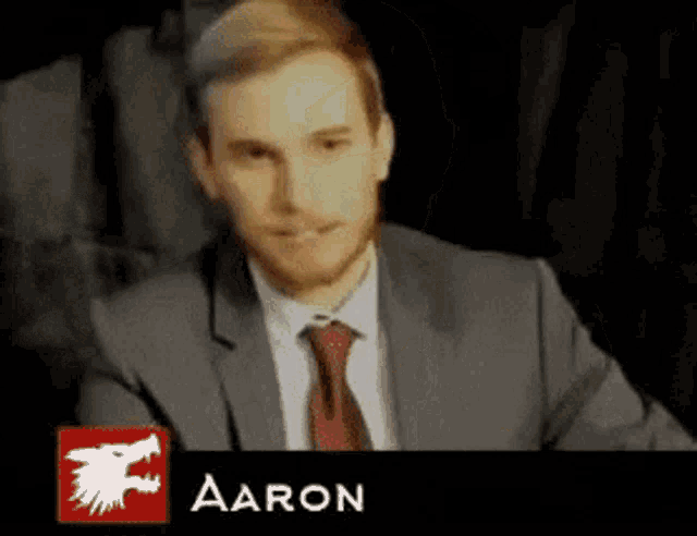 a man in a suit and tie with the name aaron