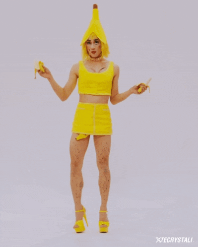 a woman wearing yellow heels is crawling on the ground