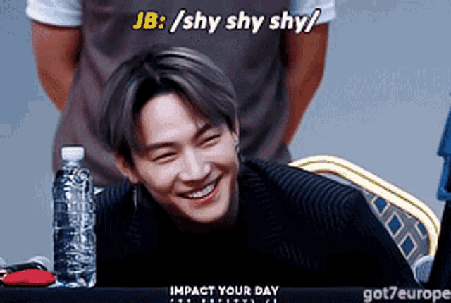 a young man is smiling with the words jb / shy shy shy written above him