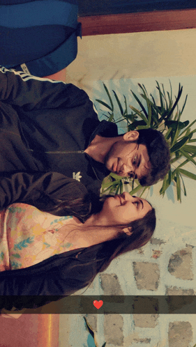 a man and a woman are looking at each other and the man has an adidas jacket on