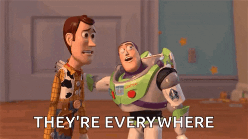 woody and buzz lightyear from toy story are standing next to each other on a wooden floor and they are everywhere .