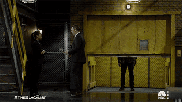 a nbc advertisement for the blacklist shows a man and woman standing in front of a yellow door