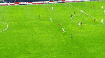 a blurry picture of a soccer game with a goalie wearing a number 20 jersey