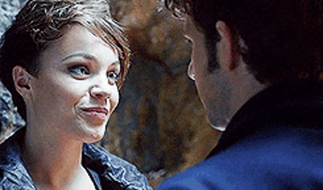 a man and a woman are looking into each other 's eyes