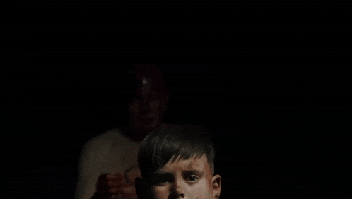 a man with a crown of thorns on his head and a child with bloody hands