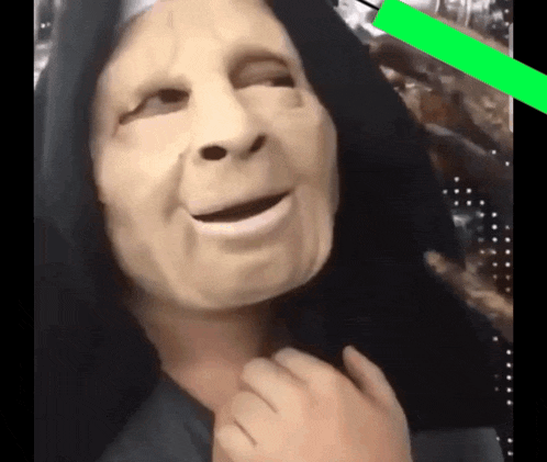 a person with a mask on their face and a black hood