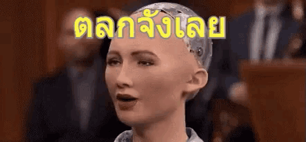 a robot with a bald head is talking in a foreign language