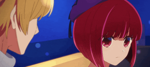 a girl with red hair and a purple hat looks at a boy
