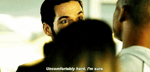 a man is talking to another man and says `` uncomfortably hard , i 'm sure '' .