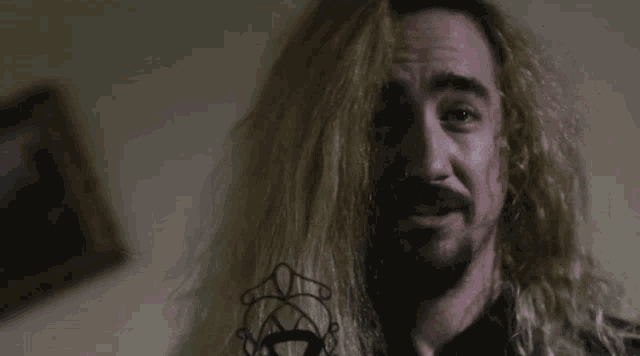 a man with long blonde hair and the words mondd ki a mondatod on the bottom