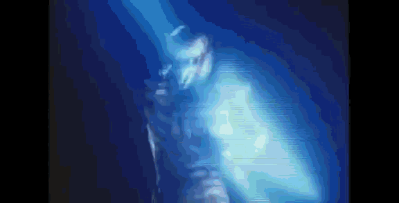 a person is standing in a dark room with a blue light coming from behind them .