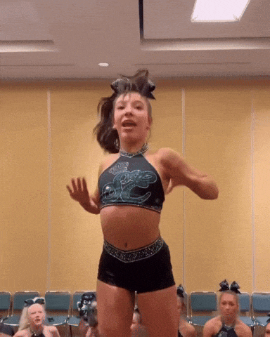 a cheerleader wearing a top that says ' panthers ' on it