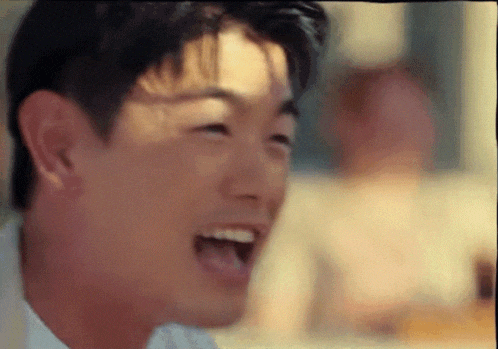 a close up of a man 's face with his mouth wide open