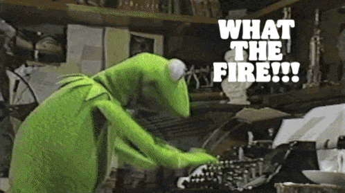 kermit the frog is typing on a typewriter with the words what the fire written above him