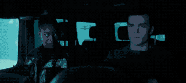 a man and a woman are sitting in the back seat of a car with their eyes closed