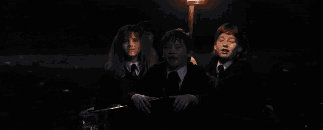 a group of children sitting in a dark room