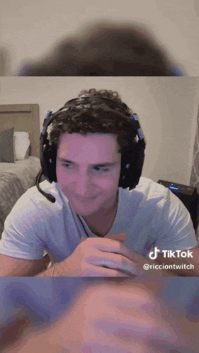 a man wearing headphones and a white shirt has a tiktok icon on the bottom right
