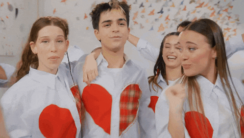 a group of people wearing white shirts with hearts on them