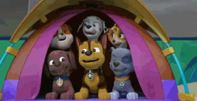 a group of cartoon dogs are sitting inside of a tent .