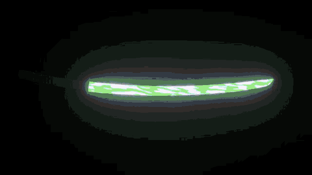 a purple glowing object in the dark with the word jesus on it