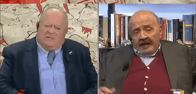 a man in a suit and tie is talking to another man in a red vest with the words diretta on the bottom