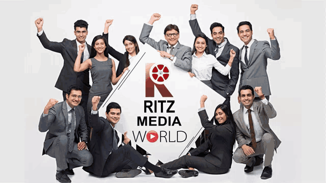 a group of people posing in front of a ritz media world logo