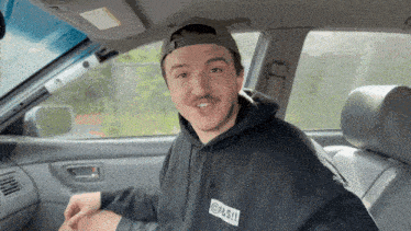 a man wearing a hat and a hoodie that says " it 's "