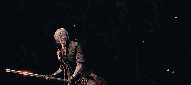 a blurry image of a man holding a sword over a fire
