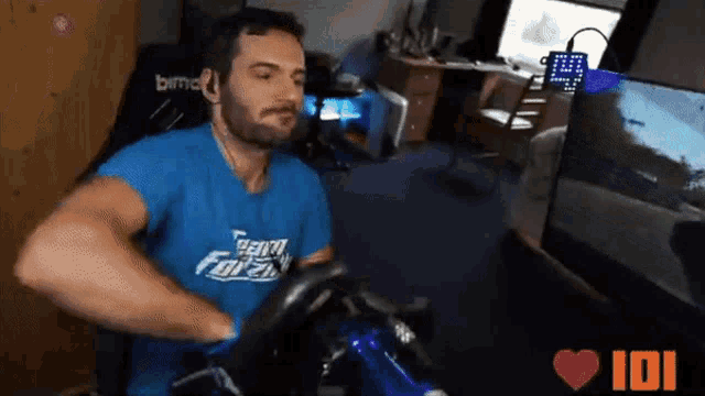 a man wearing a blue shirt that says forza