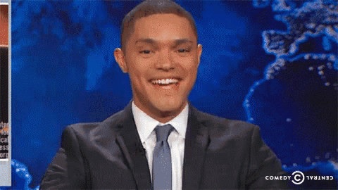 a man in a suit and tie is smiling with his hands in the air ..