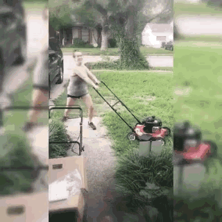 a man is pushing a lawn mower on a sidewalk .